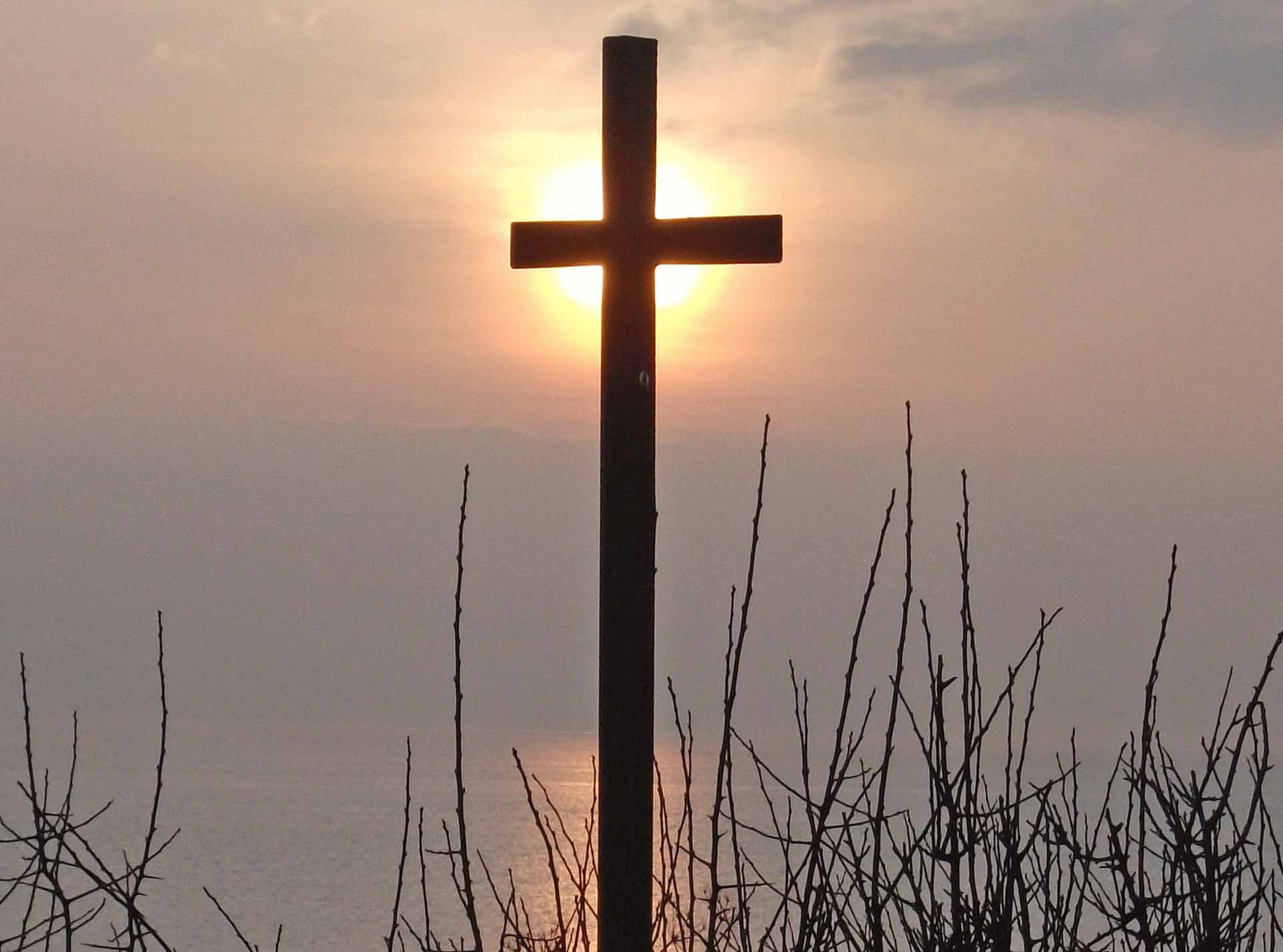 a cross against a sunset